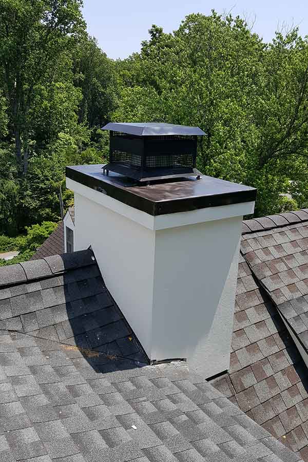 Chimney Guys VA original photo - After Stucco and Chase Cover Repair After Stucco and Chase Cover Repair stainless steel in brown trees in background